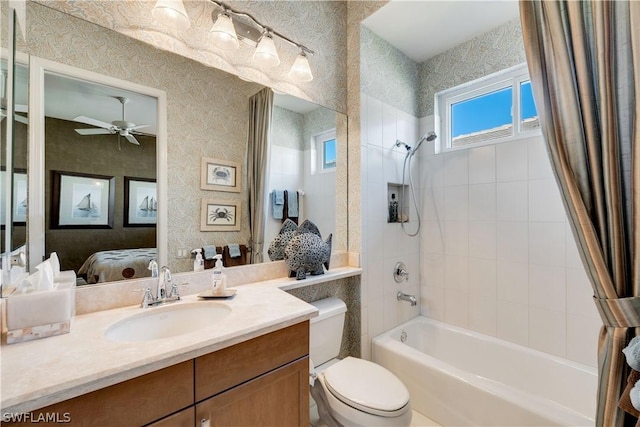full bathroom featuring ceiling fan, vanity, toilet, and shower / bath combo
