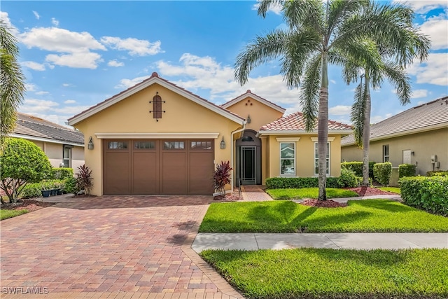 view of front of property with a garage and a front yard