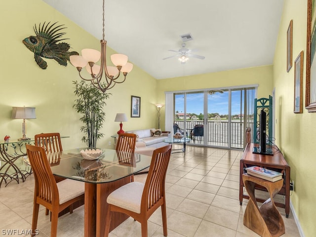 dining room with light tile flooring, vaulted ceiling, and ceiling fan with notable chandelier