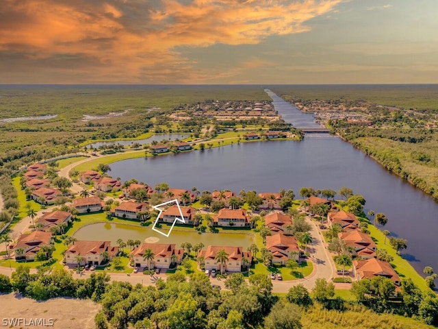 aerial view at dusk with a water view