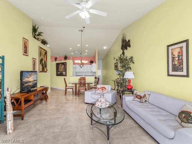 living room featuring lofted ceiling, ceiling fan with notable chandelier, and light tile floors