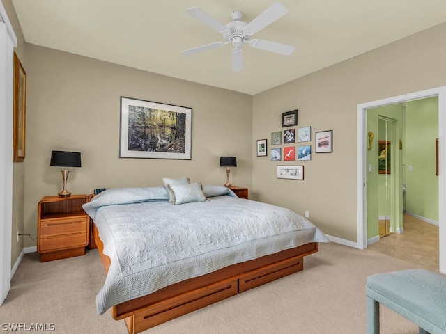 tiled bedroom with connected bathroom and ceiling fan