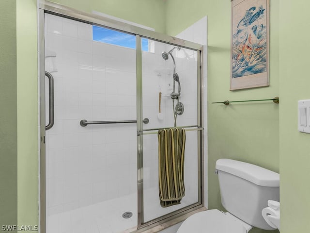 bathroom with walk in shower and toilet