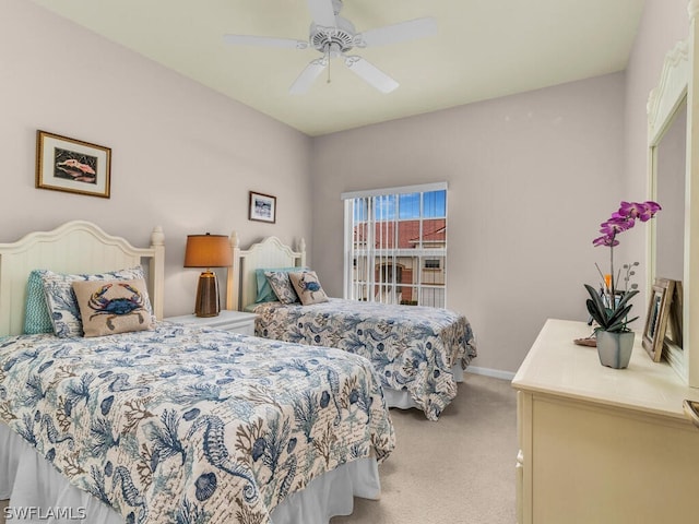 bedroom featuring light colored carpet and ceiling fan