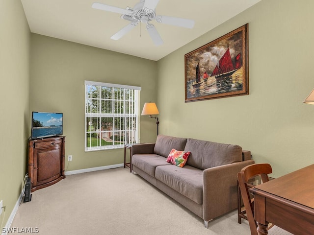 living room featuring ceiling fan and light colored carpet