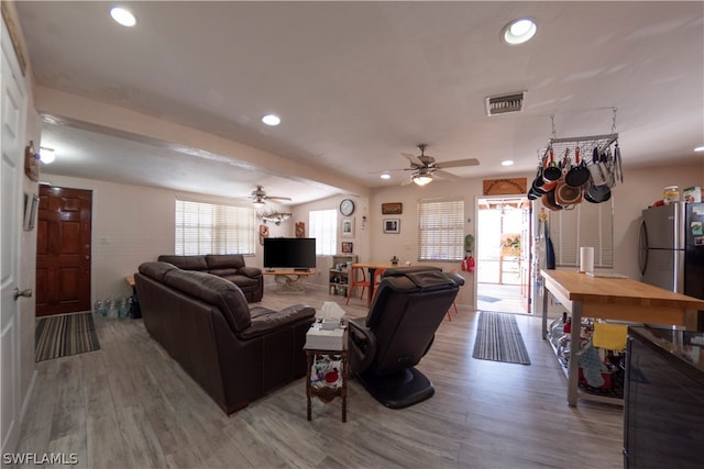 living room featuring hardwood / wood-style flooring and ceiling fan