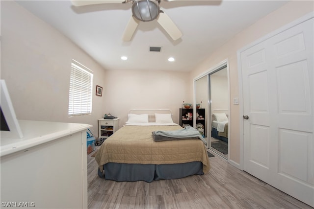 bedroom featuring a closet, light wood-type flooring, and ceiling fan