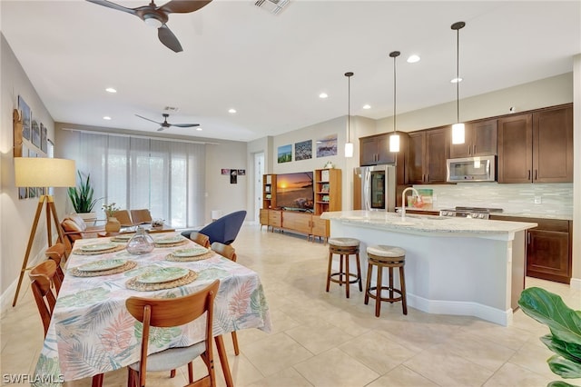 dining space with baseboards, visible vents, a ceiling fan, and recessed lighting