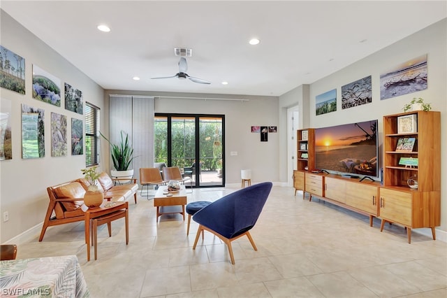 living room with baseboards, visible vents, a ceiling fan, and recessed lighting