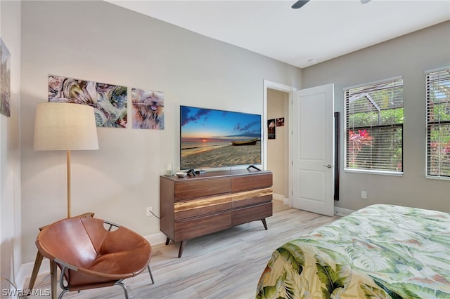 bedroom featuring light wood-style flooring and baseboards