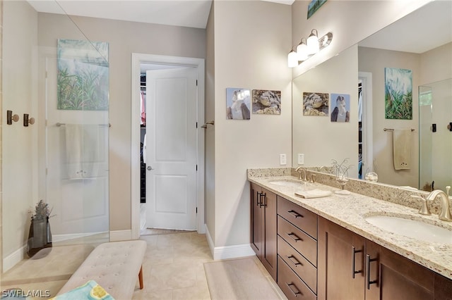 bathroom with tile patterned floors, double vanity, a sink, and an enclosed shower