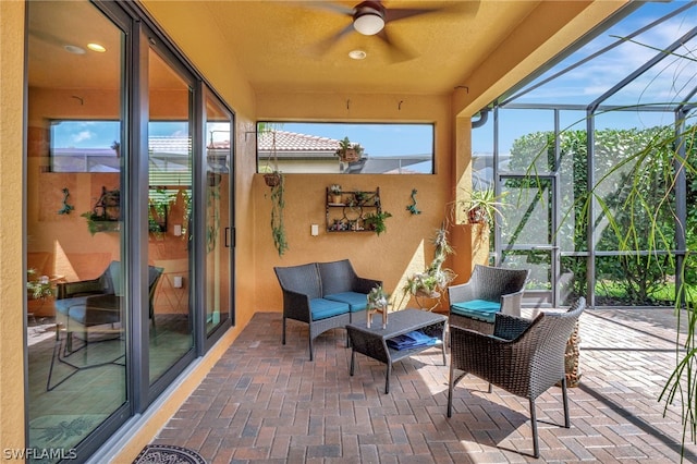 sunroom featuring ceiling fan