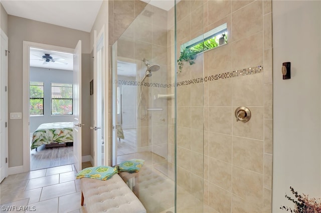 bathroom with ensuite bath, baseboards, tiled shower, and tile patterned floors