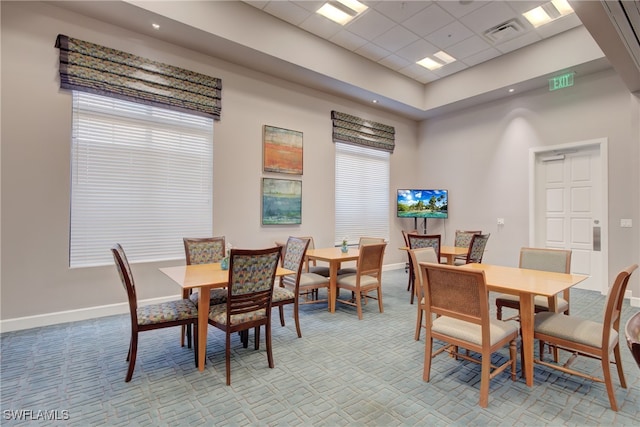 dining space with light carpet, visible vents, and baseboards