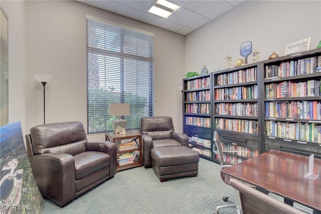 carpeted office space featuring a drop ceiling