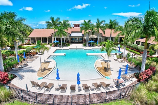 pool with a patio and fence