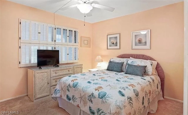 bedroom with ceiling fan and light colored carpet