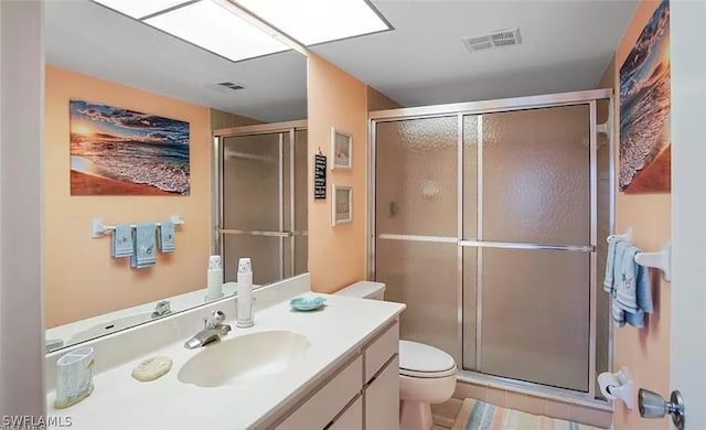 bathroom with oversized vanity, toilet, walk in shower, and tile flooring