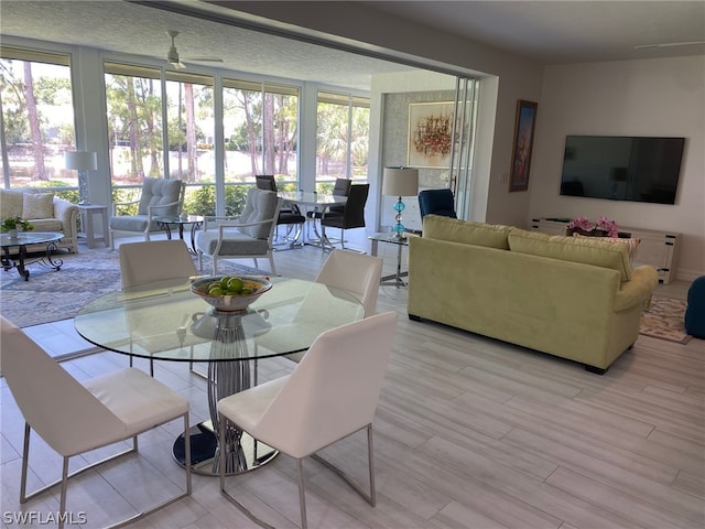 dining area featuring light hardwood / wood-style flooring and ceiling fan