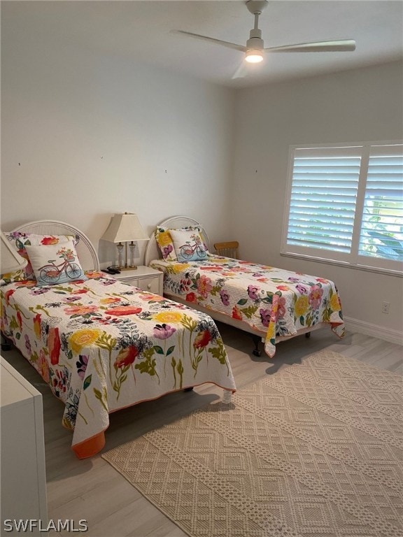 bedroom with ceiling fan and light hardwood / wood-style floors