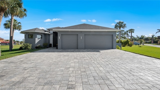 view of front of property with a front lawn and a garage