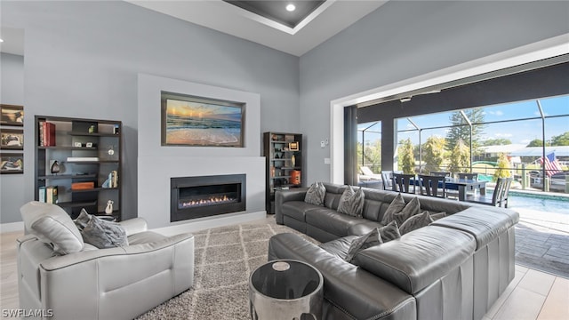 living room featuring light tile floors and a towering ceiling