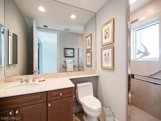 bathroom featuring vanity, toilet, and a shower with door