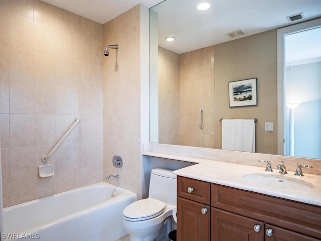 full bathroom with vanity, tiled shower / bath, and toilet