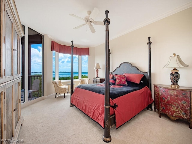 carpeted bedroom featuring access to exterior, ceiling fan, crown molding, and a water view