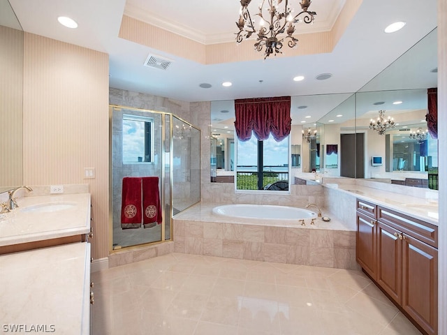 bathroom featuring a raised ceiling, vanity, and shower with separate bathtub