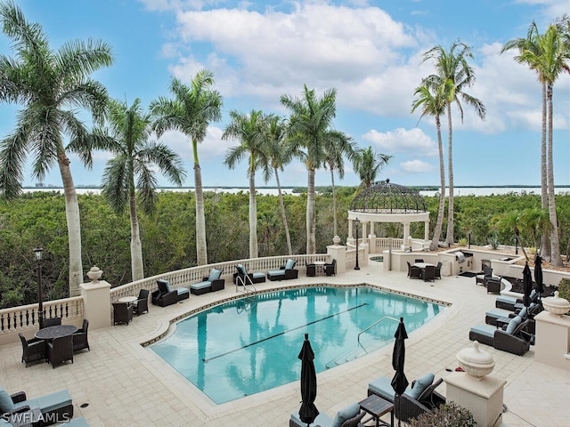 view of swimming pool with a gazebo, an outdoor living space, and a patio area