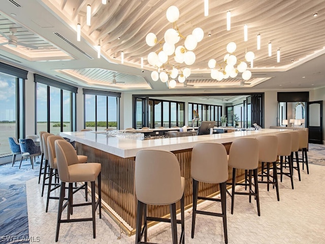 bar featuring crown molding, floor to ceiling windows, and a notable chandelier