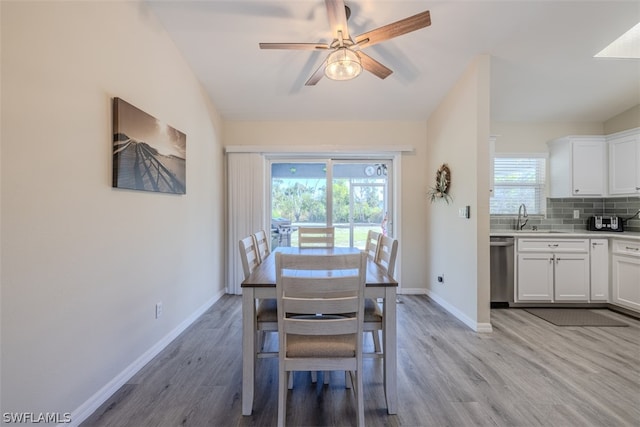 dining space with lofted ceiling, ceiling fan, light hardwood / wood-style flooring, and sink