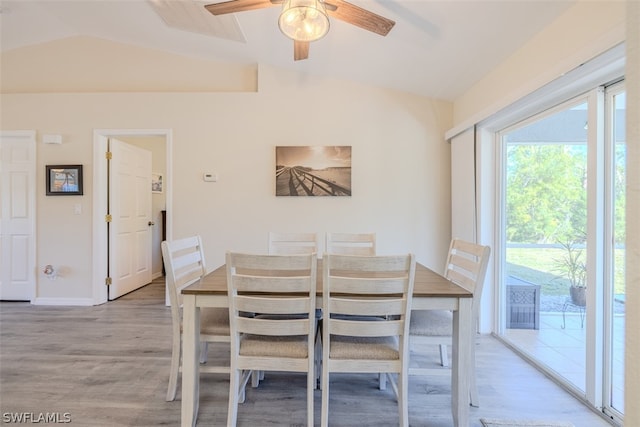 dining area featuring light hardwood / wood-style flooring, vaulted ceiling, and ceiling fan