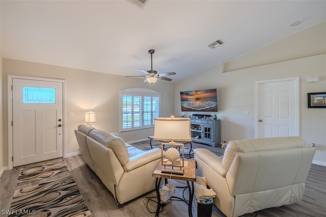 living room with dark hardwood / wood-style floors, vaulted ceiling, and ceiling fan