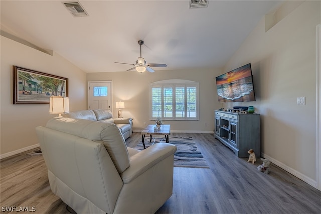 living room featuring light hardwood / wood-style floors, ceiling fan, and lofted ceiling