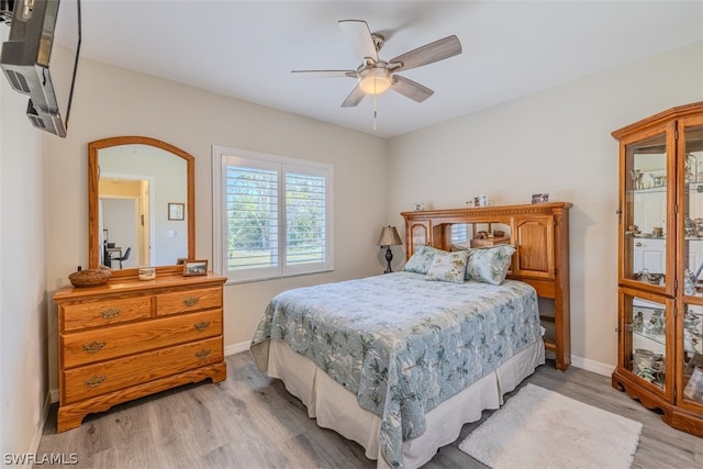 bedroom with light hardwood / wood-style floors and ceiling fan