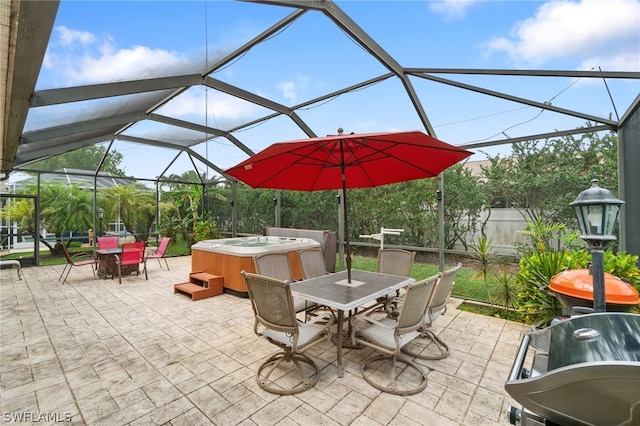 view of patio / terrace featuring glass enclosure and a hot tub