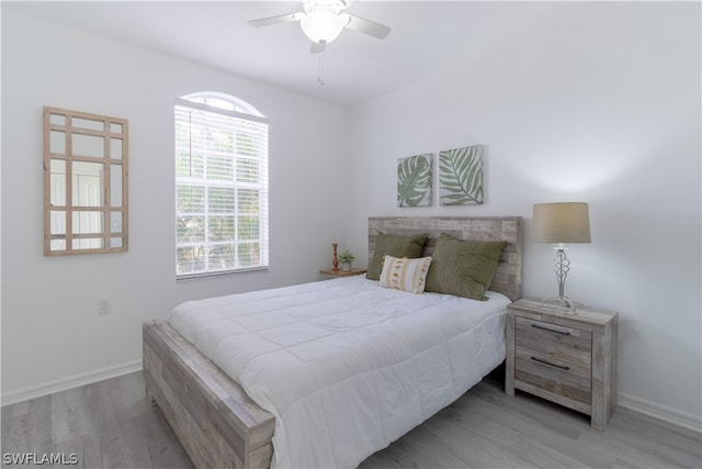 bedroom with light hardwood / wood-style floors and ceiling fan