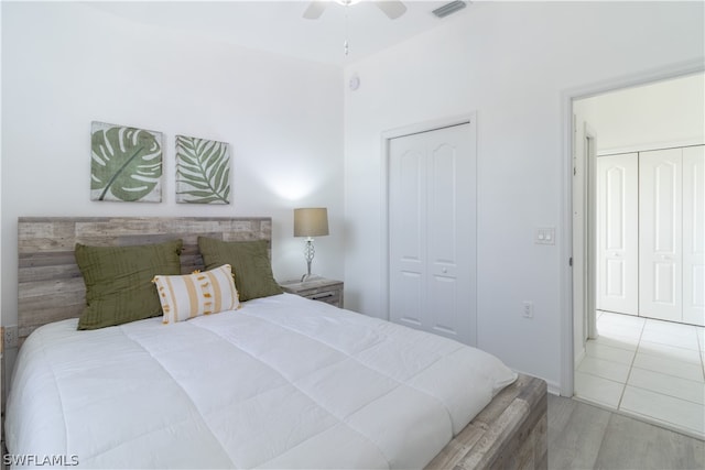 tiled bedroom with ceiling fan