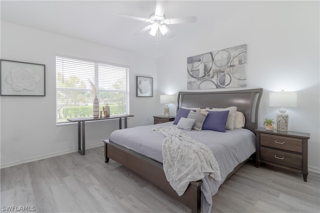 bedroom with light hardwood / wood-style floors and ceiling fan