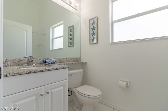 bathroom featuring tile flooring, oversized vanity, and toilet