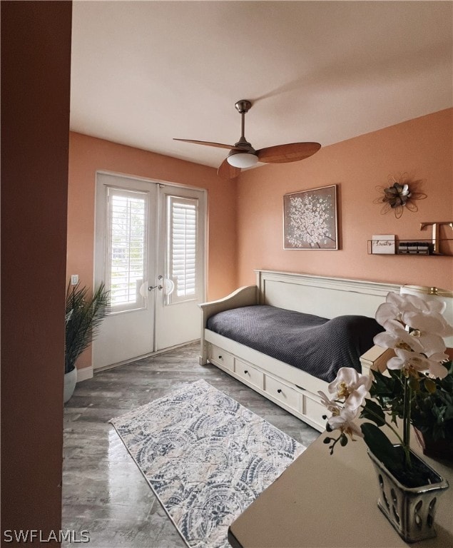 bedroom with french doors, ceiling fan, and dark hardwood / wood-style flooring