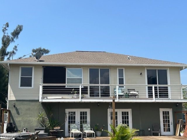 rear view of house featuring french doors and a balcony