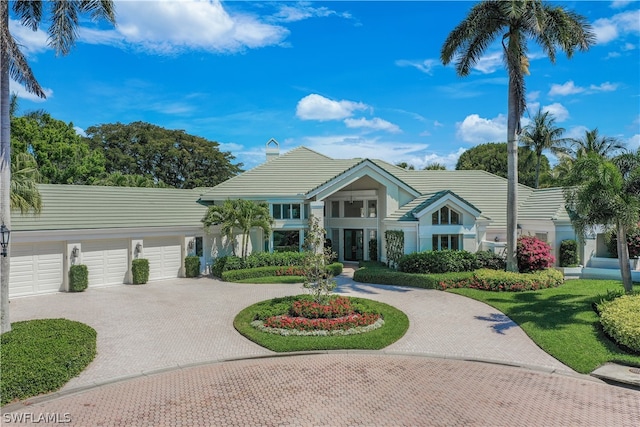 view of front of house featuring a front yard and a garage