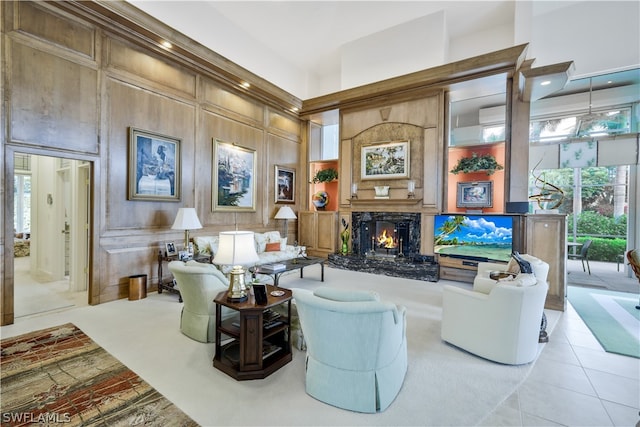 tiled living room featuring a fireplace, a towering ceiling, and a wealth of natural light