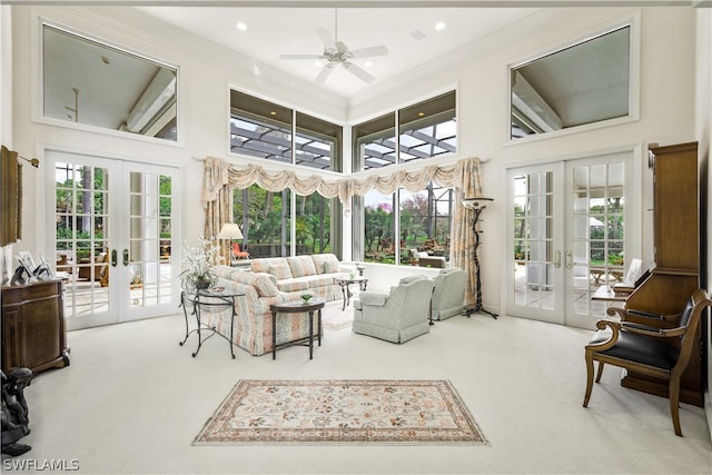 sunroom / solarium featuring ceiling fan, a healthy amount of sunlight, and french doors