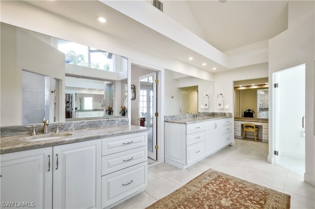 bathroom with vanity, tile patterned flooring, and high vaulted ceiling