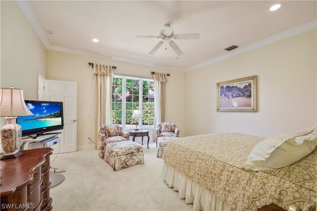 carpeted bedroom with ceiling fan and ornamental molding