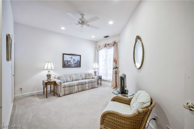 carpeted living room featuring ceiling fan